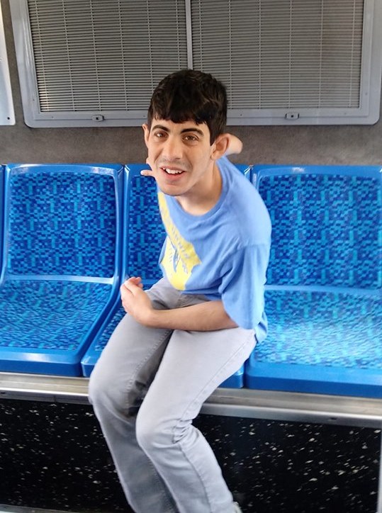 A student sitting on a bus seat